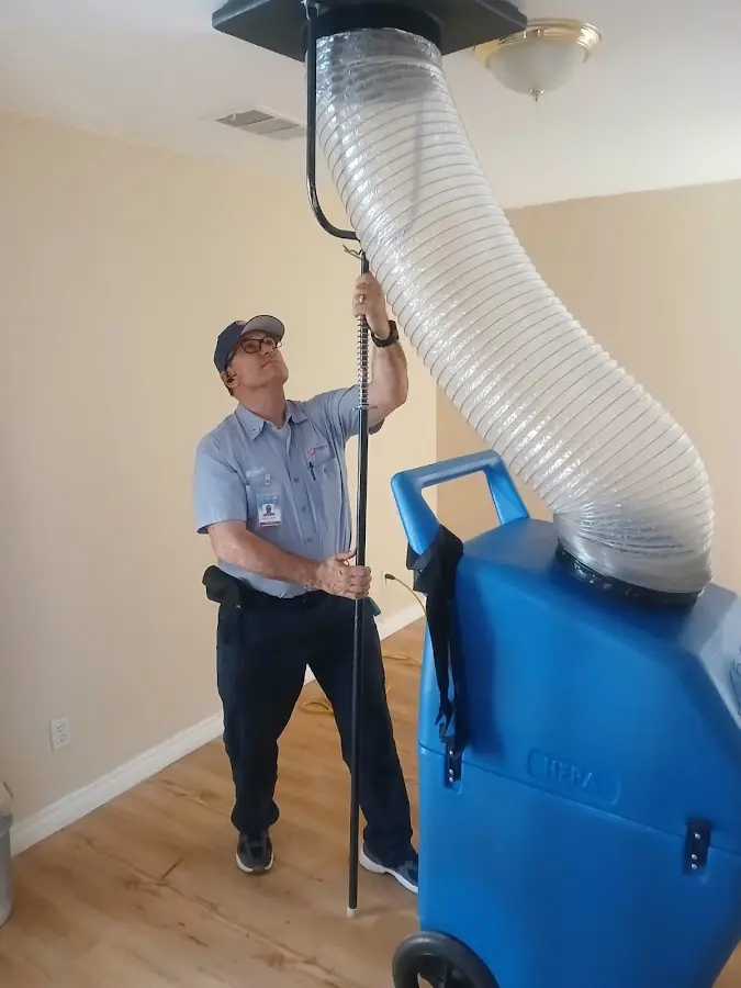 Furnace Tune-Up technician using HEPA equipment in Greenwood Village